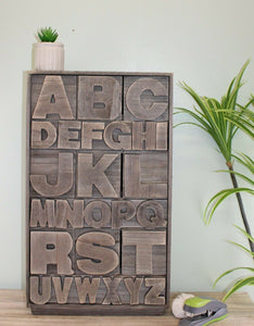 Grey wooden storage unit alphabet design